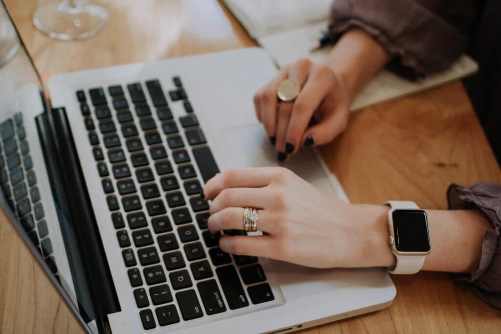 Woman writing on laptop