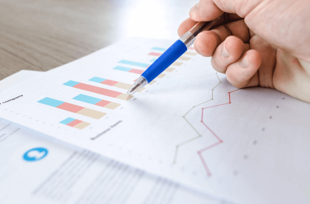 Person pointing at graphs